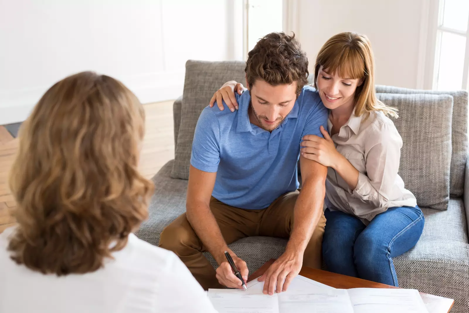 Young couple owners signing a contract